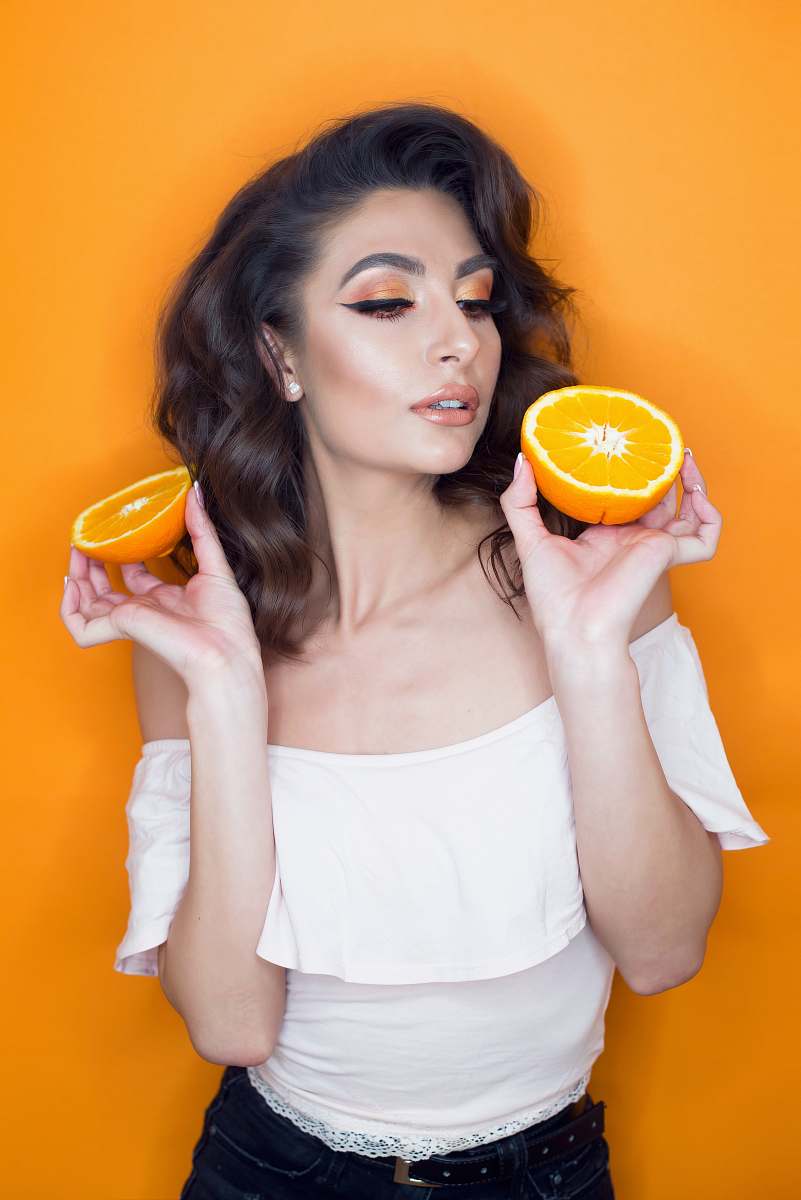 citrus fruit woman holding sliced orange fruit